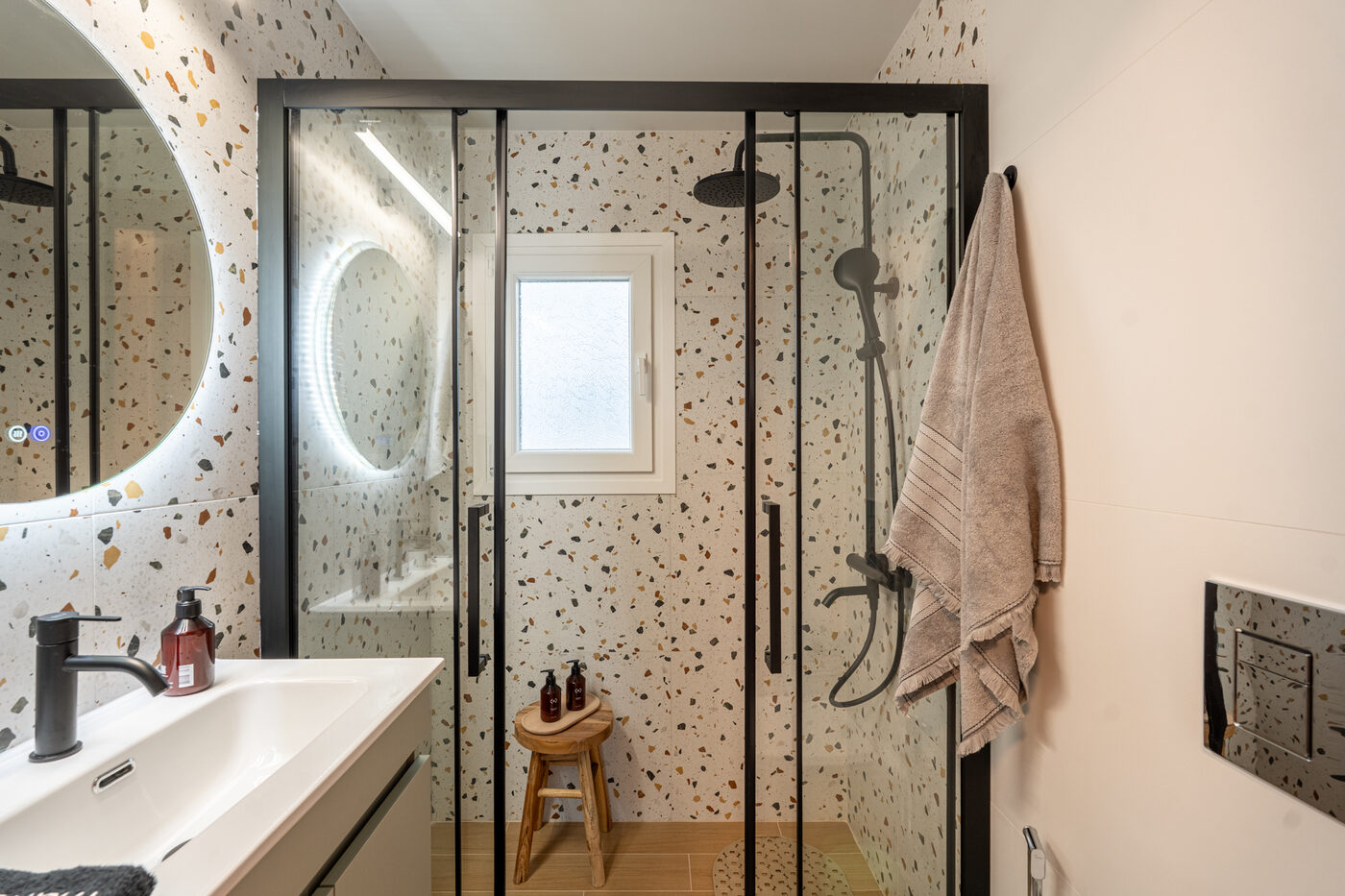 Pnoè Loft Studio — designer terrazzo bathroom with rain shower