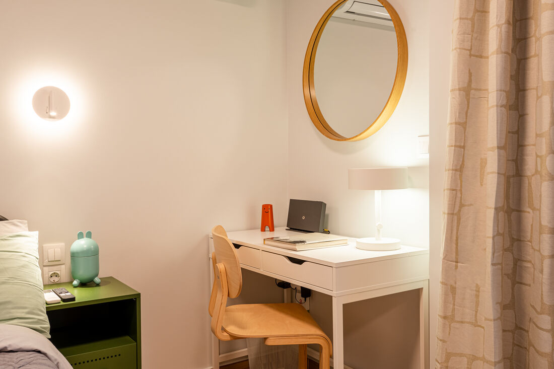 Bedroom workspace desk with round mirror