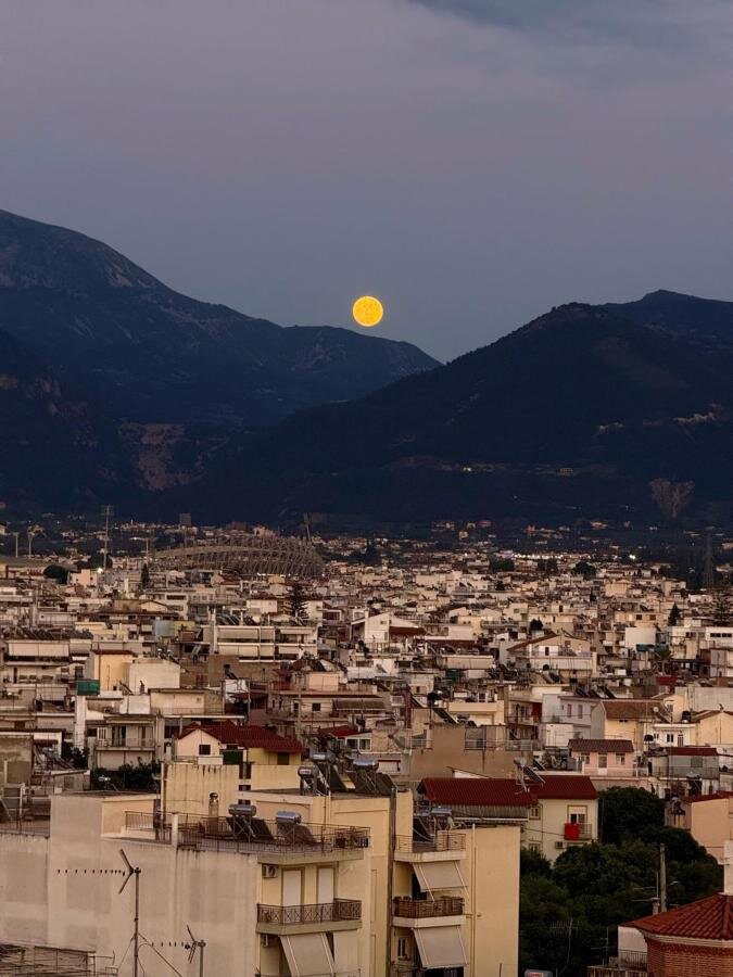 Full moon rising over the mountains at dusk