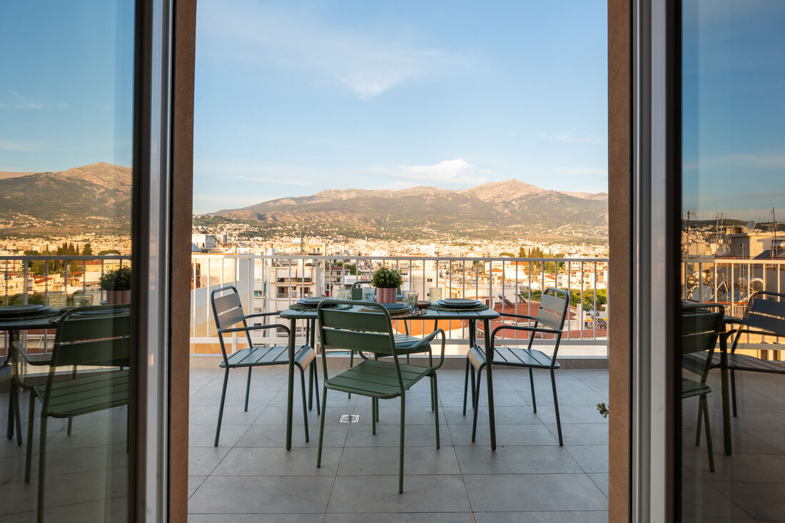 Mountain and city view through the terrace doors